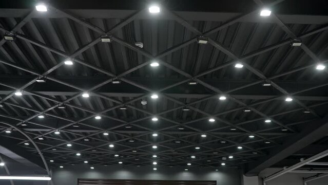 Modern ceiling in a car repair shop. Steel roof frame, Car repair service center, The interior of a big industrial building or factory with steel constructions, inside the roof structure.