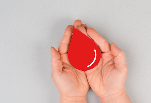 Holding a red drop in the hands, donate blood, world blood donor day, health care, transfusion