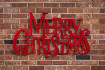 Merry Christmas sign on a brick wall