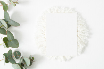 Minimalist wedding mockup card with eucalyptus leaves on the white background