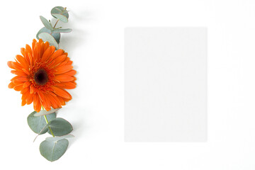 Wedding mockup card with orange gerbera and eucalyptus leaves on the white background
