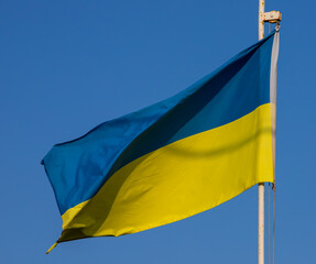 Ukraine flag isolated on sky background. close up waving flag of Ukraine. flag symbols of Ukraine