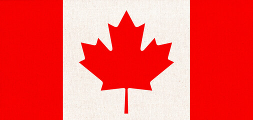 Flag of Canada. Canadian flag on fabric surface with red maple leaf on white