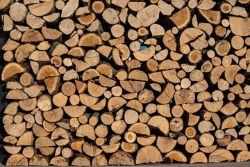 Pile of stacked triangle firewood prepared for fireplace and boiler