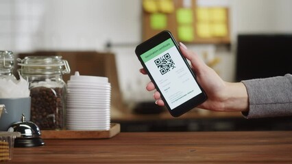 QR code, covid vaccination passport control close-up. Scanning coronavirus electronic medical certificate on smartphone in cafe or restaurant, green zone. - Powered by Adobe