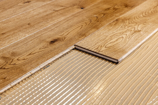 parquet floor installation. wooden planks on flooring glue