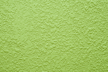 Bright light green background. Abstract texture of plaster or wallpaper.