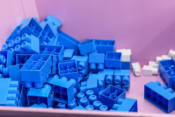 Kids toys; bright blue plastic blocks. many toy blocks in a box used to teach children