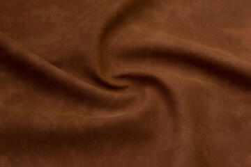 brown artificial leather with waves and folds on PVC base