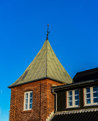 Obraz premium Brick house with pointed copper roof, in norre vorupor denmark