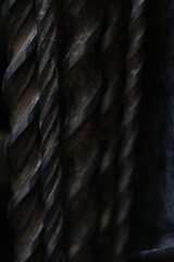 Close up dark image of used metal drill bits showing spirals