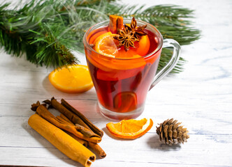 mulled wine in a glass cup on a wooden background