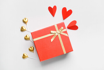 Gift for Valentine's Day and hearts on white background