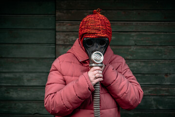 Woman with old gas mask and hat on it. Concept - Nuclear Disarmament and Radiation Protection,...