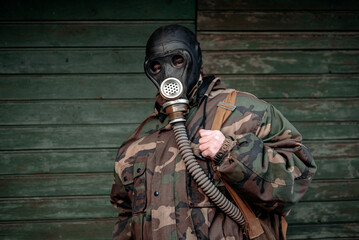 Woman with old gas mask and army jacket. Concept - Nuclear Disarmament and Radiation Protection,...