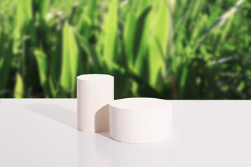 Empty cylindrical podium or pedestal on white background with green grass. Blank shelf product standing background