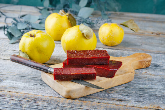 Traditional Spanish dulce de membrillo as fruit bread with quince as close-up on a wooden board
