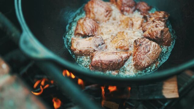 Step by step cooking of Pilaf in cauldron on fire.