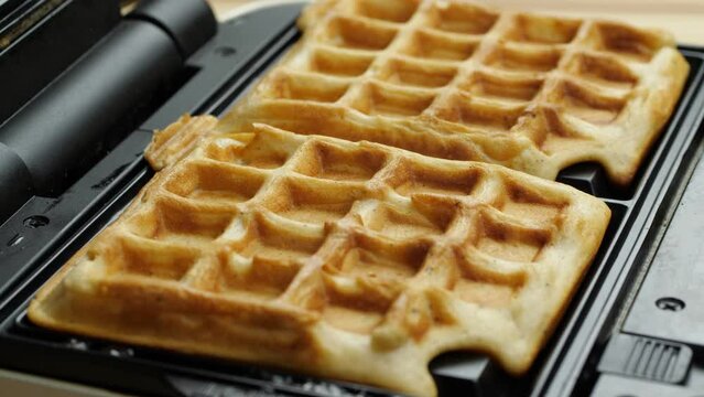Freshly baked waffles in waffle iron