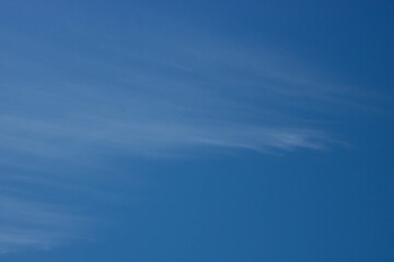 Beautiful sky background. Unusual cirrus clouds in the blue sky