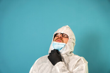 Doctor wearing disposable coverall with mask and google shows thumb up. Pandemic Covid 19