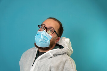 Doctor wearing disposable coverall with mask and google shows thumb up. Pandemic Covid 19