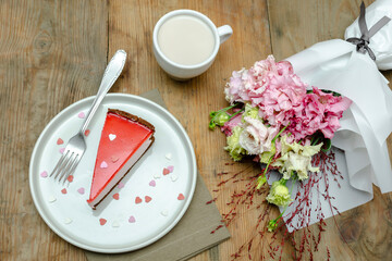 red jelly cheesecake, sweet dessert with flowers, cup of coffee on wooden table background. gift to woman on March 8 holiday, valentine's day breakfast food, international Women's Day