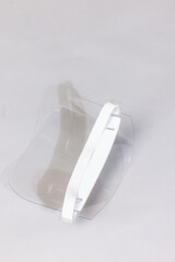 Plastic face shield for covid virus protection. Transparent face shield isolated on white. Surgical or medical staff equipment. Covid epidemy spread protection. Respiratory syndrome or flu prevention