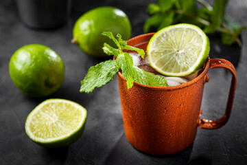 Moscow mule cocktail in copper mug on the table.