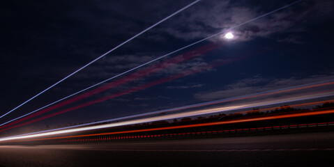 lights of cars with night. long exposure, moon and sky