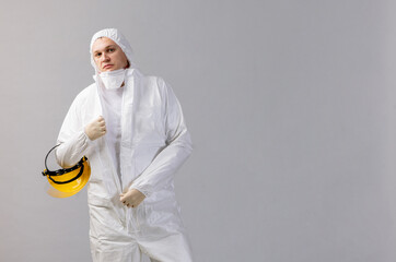 Tired doctor wearing mask and gloves at the hospital in coronavirus times, checking his smartphone.