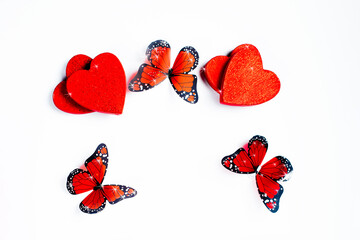 Valentine s day concept.Red hearts with butterflies on a white background.Template on the theme of valentine's day, romantic letterhead for cards, invitations, copy space.Valentine s day concept.
