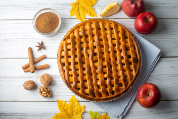 Homemade Apple Pies on a white wooden background, top view. The classic fall Thanksgiving dessert -...