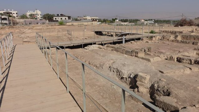Walking past excavated ruins of Hisham's Palace in Jericho, ancient city in the Palestinian Territories
