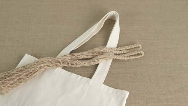 Handmade bags. A view of a cotton bag and a string mesh on the table.
