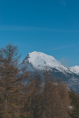 A picturesque vertical landscape view of the French Alps mountains on a cold winter day (La Joue du Loup, Devoluy)