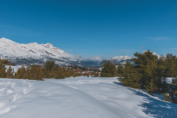 A picturesque landscape view of the French Alps mountains on a cold winter day (La Joue du Loup, Devoluy)