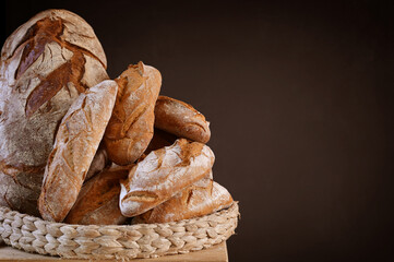 Basket of artisan breads s with copy space on brown blackboard
