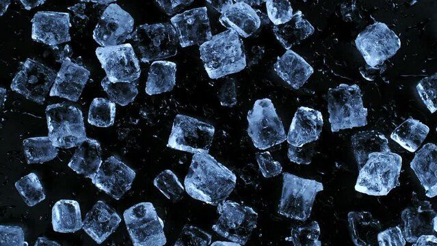 Super slow motion of falling ice cubes separated on black background. Filmed on high speed cinema camera, 1000 fps. Speed ramp effect.