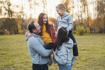 Fototapeta premium Photo with a caucasian family relaxing in park together. Family time.