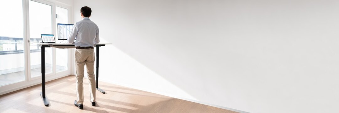 Man Working On Computer At Standing Desk