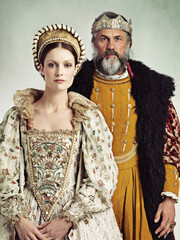 Noble rulers. Portrait of a stern-looking king and queen.