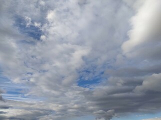 Clouds in the blue sky. Sky with gray and white clouds, background, thunderclouds, unstable changeable weather, storm clouds background.