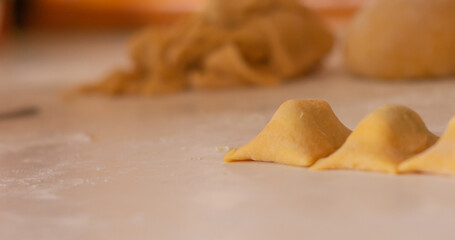 Fresh homemade italian pasta ravioli filled and stacked. Cooking process. Selective focus. Raw food with copyspace.