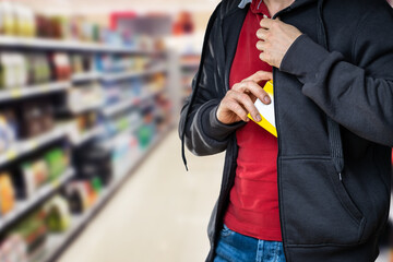 Retail Shoplifting. Man Stealing In Supermarket - obrazy, fototapety, plakaty