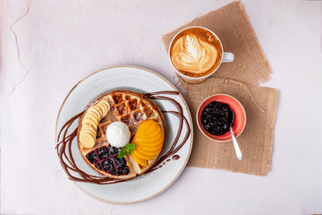 top view waffles with banana, kiwi, ice cream and coffee
