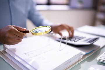 Auditor Using Magnifying Glass For Audit