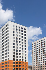 New modern residential apartment buildings newly build on blue cloudy sky
