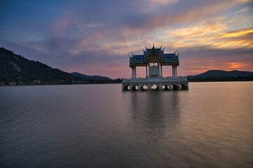 Buddhist Shrine On A Lake In Hua Hin In Thailand At Sunset! The Temel is reflected in the water and the sky turns red!