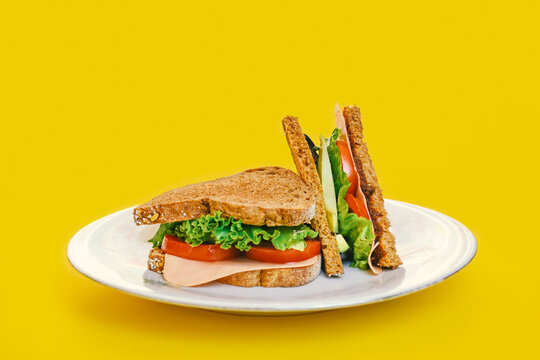 Healthy sandwich with whole grain bread, vegan ham, tomato, lettuce and avocado.